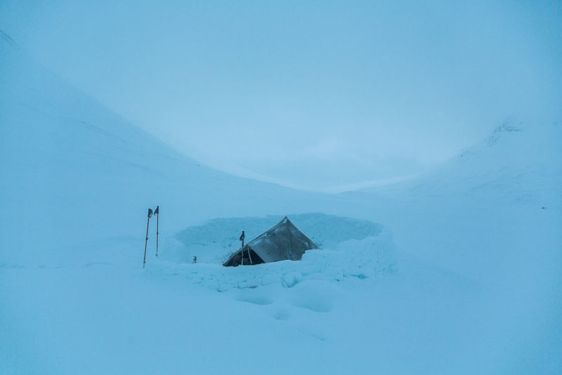 Early morning deep in the heart of the Cairngorms, and a wall made from 2-inch windslab tiles to protect our shared shelter from the gale