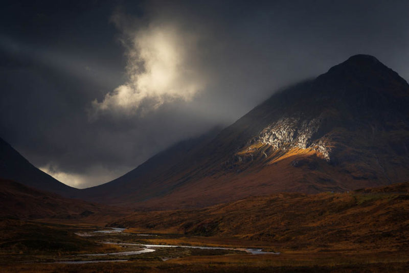 Winner of the 'Sunday Times Choice Award' - UK Landscape Photographer of the Year 2015. This was one of those special moments when the elements compose themselves before me like a fleeting gift to be grabbed in the brief moment its offered. I have lost count of the times opportunities have been forever lost while frantically getting into place and getting the camera set up. I noticed a break appearing in the heavy sky over Buachaille Etive Mor and a shaft of silvered light punctured through. It began to glide its way across Lairig Gartain and I started to shoot off frames hand held for fear of missing out by setting up the tripod. The ray of light began to glitter off the wet rock on the side of Stob nan Cabar and illuminated an lone angel-like cloud morphing over the Coupall, the reflection defined the river below perfectly.